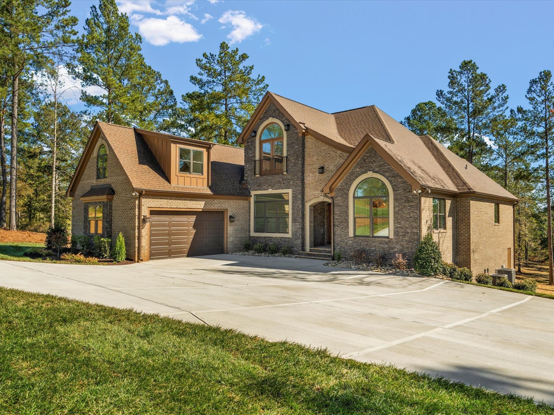 Stone luxury custom home exterior by BWA Builders